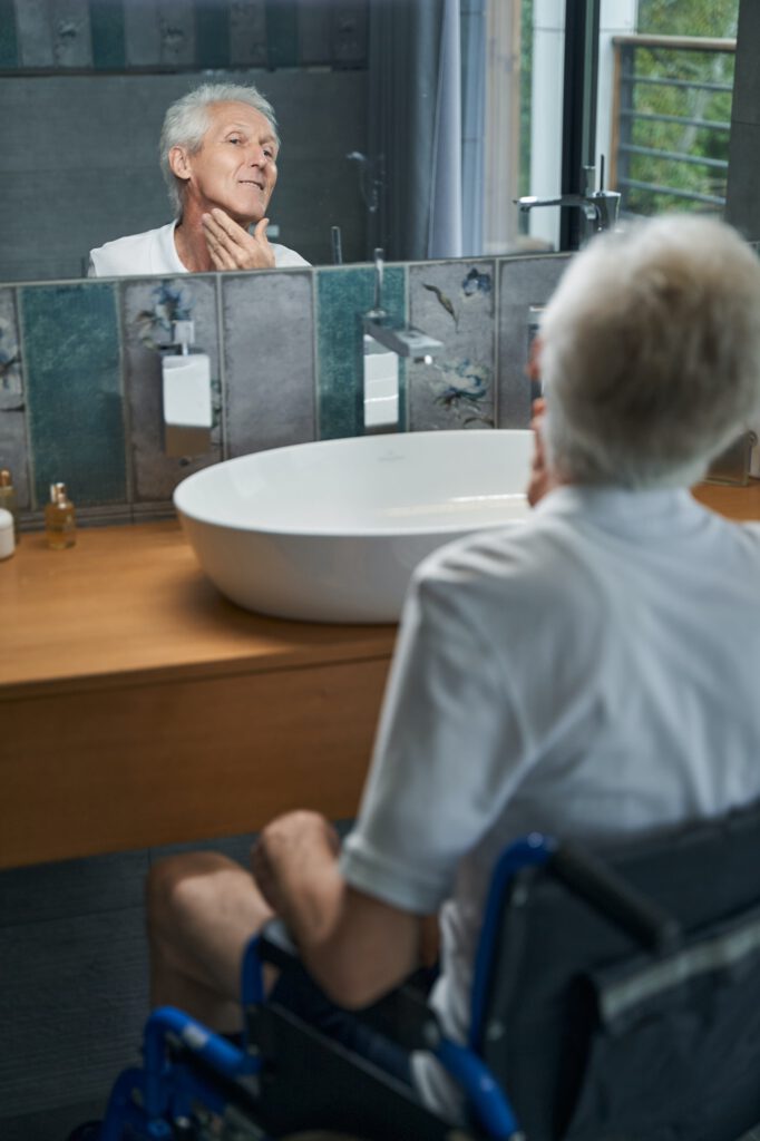 Disabled male person looking at his reflection